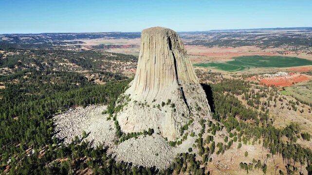 Aerial drone view of Devils Tower National Monument rising dramatically above the surrounding landscape in Wyoming, US