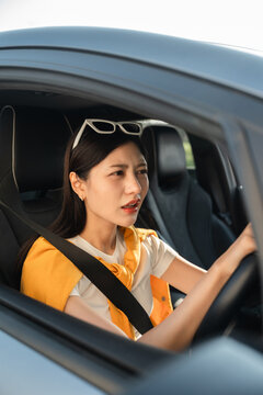 Young asian woman has broken down car on the road she feeling serious and stressed.Look for someone help. Driving during rush hour But the traffic is very congested. Shocked face