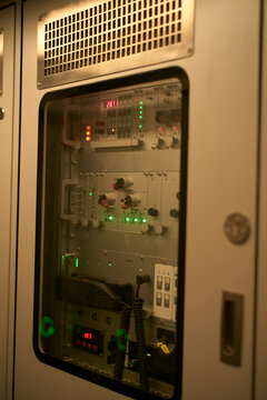A close-up view of a control panel with various buttons and indicator lights inside a casing. Zurich, Switzerland