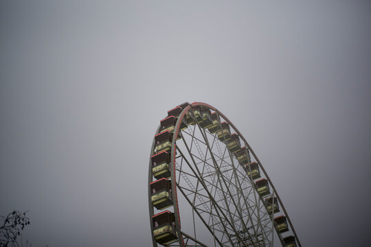 Ferris wheel against a gray sky on a foggy day Brussels, Belgium