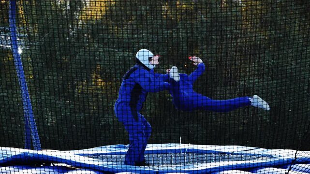 People taking indoor skydiving lessons experiencing freefall in a wind tunnel