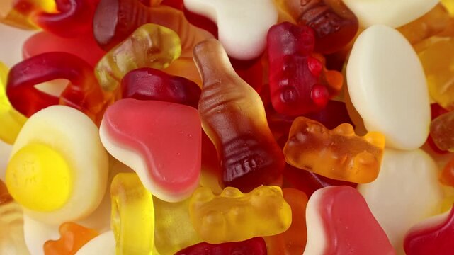 Assorted colorful gummy jelly candies circle rotation close up