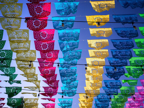 Colorful papel picado banners hang against a clear blue sky, creating a festive atmosphere. San Jose del Cabo, Baja California Sur, Mexico
