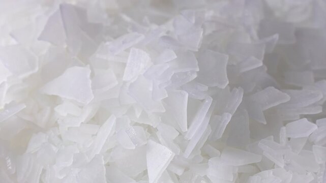 Magnesium Chloride flakes or Bischofite (Magnesium Bath Salt) texture circle rotation close up