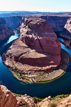 Majestic view of Horseshoe Bend with deep blue water winding around red rock formations. Horseshoe Bend, Colorado River, Arizona, USA