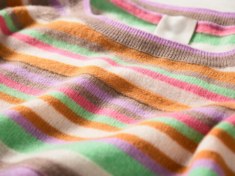 Striped knit fabric with vivid colors like orange, pink, green, and purple. Germany