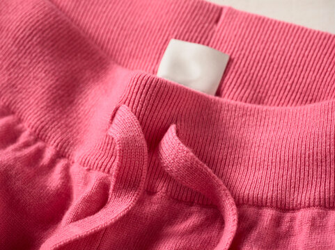 Close-up of pink sweatpants with a drawstring and elastic waistband. Germany