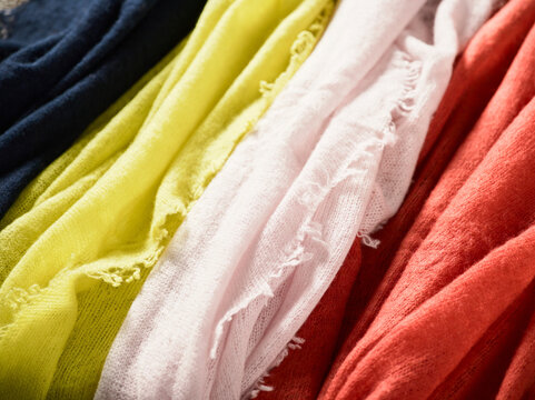 Brightly colored fabric swatches in shades of navy, yellow, cream, pink, and orange. Germany