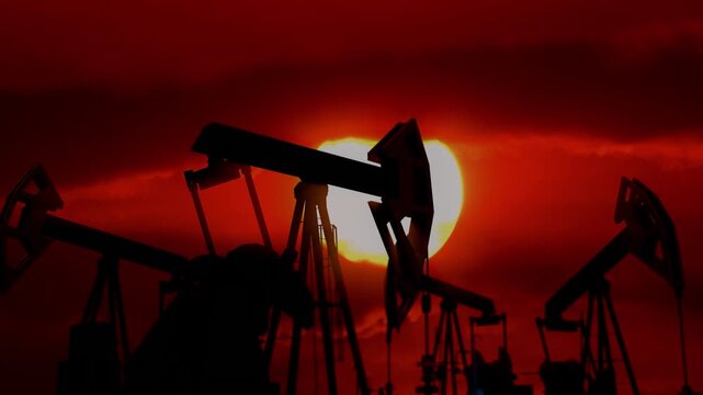 Oil production in the sunset: the balance between progress and nature. Oil pumps