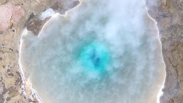 Flying above the Great Geyser, geysir in the Golden Circle, Iceland, slow motion aerial view