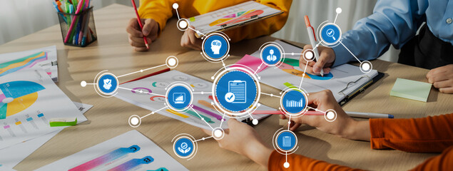 A vibrant business strategy meeting showcasing teamwork and data analysis. Participants engage with...