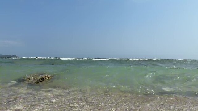 Original 4K 120fps high frame rate (HFR) landscape shot of rolling ocean waves and white sea foam washing onto the shore. Real-time playback, ideal for ultra-smooth slow motion editing.