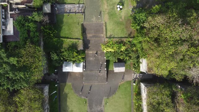 Cinematic top down aerial drone flying slowly forward above Plaza Garuda at Garuda Wisnu Kencana Cultural Park in Bali, Indonesia.