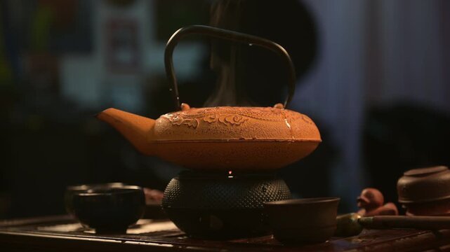 Chinese yellow teapot on rustic wooden tray
