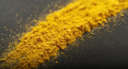 Fototapeta premium high detail macro of yellow powdery material on dark surface with soft lighting