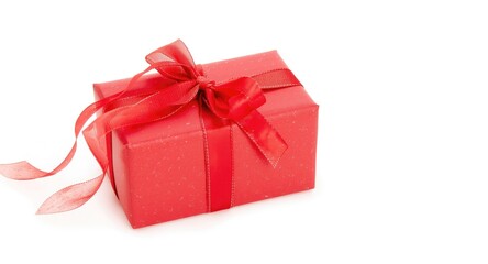 Obraz premium Red gift wrapped elegantly with ribbon bow on fresh white backdrop