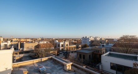 Fototapeta premium Fictional elevated city view with sunlit rooftops and clear blue sky
