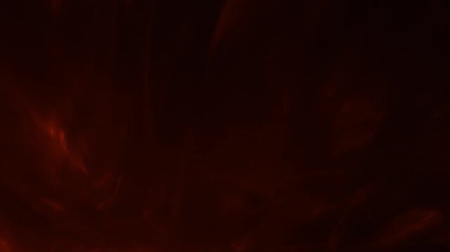 dramatic swirling crimson smoke billows mysteriously through deep black void with fiery glowing highlights