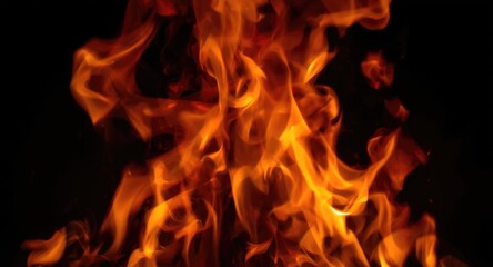 Fototapeta premium Macro image showing lively flames swirling in dark