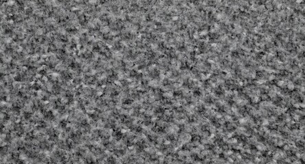 Fototapeta premium Gray knitted material close up highlighting textured weave