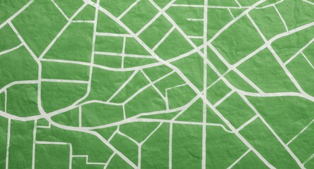 Naklejka premium Graphic of city road system in white on a green textured paper surface viewed from above