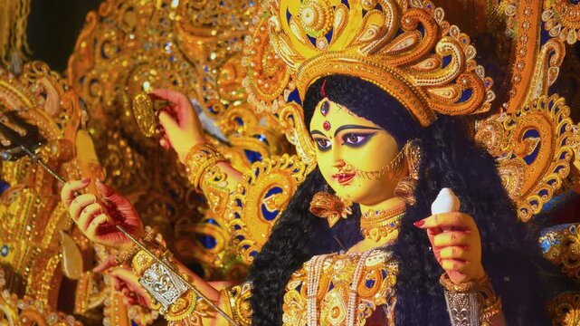 Detailed close-up of Goddess Durga showing three eyes and multiple hands, symbolizing divine power, protection, and spiritual strength in Hindu culture.