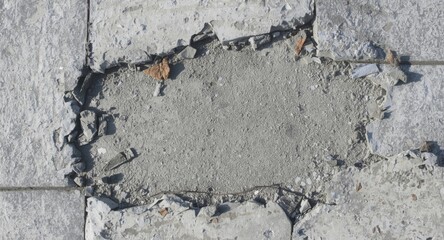 Fototapeta premium Isolated fragments of damaged concrete slabs with debris on surface