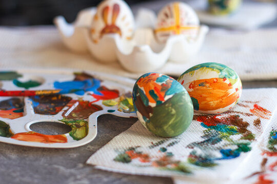 Easter eggs on the table. Children's drawings on eggs. Creative, childish, colorful, bright