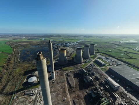Aerial view of the skeletal remains of West Burton Power Station stand stark against the verdant landscape, a monument to a bygone era, Retford, United Kingdom.