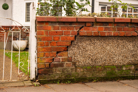 Cracked and crumbling brick wall on residential house