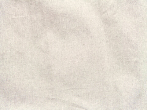 シワのある生成りの布地のテクスチャ背景素材