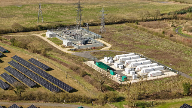 Aerial view of the Tiln Battery Energy Storage System and solar panels, a juxtaposition of modern energy solutions against a backdrop of green fields, Retford, United Kingdom.