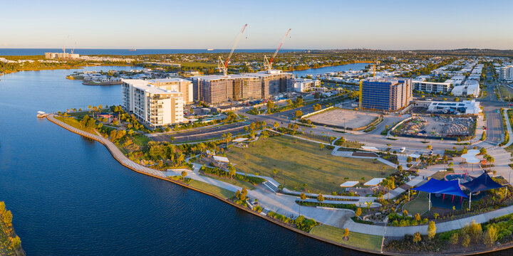 Aerial view of a new coastal development under construction along a canal
