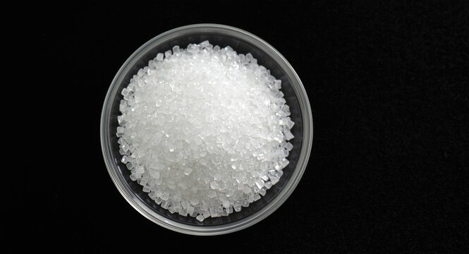 Glass dish display of antimony trioxide granules utilized as flame retardant and catalyst in plastic production