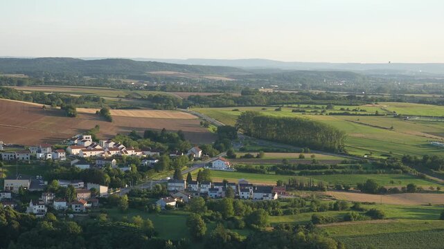 Countryside fields surround a village in Moselle, France in daylight Time lapse
