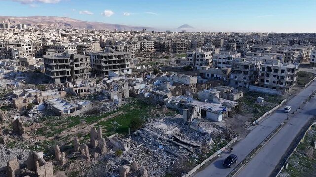 wide aerial panorama over the devastated Jobar neighborhood in Damascus, showcasing the extent of urban ruin