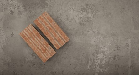 Fototapeta premium Overhead view of two bricks arranged on a muted grey flat texture background