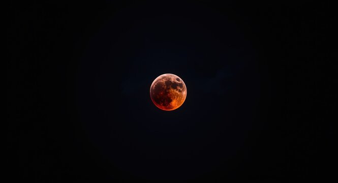 Dark sky backdrop with a vibrant super blue blood moon during total lunar eclipse