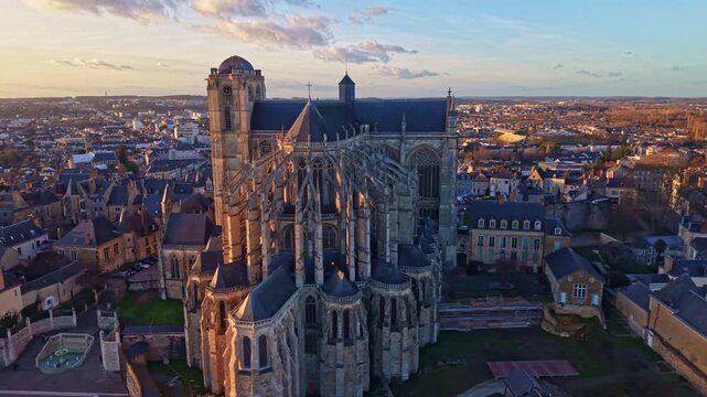 Panning drone shot of the gothic Le Mans Cathedral aka Cathedral of Saint Julian in beautiful sunset moment, Le Mans, France