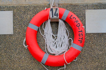 Naklejka premium safety life buoy on harbour pier