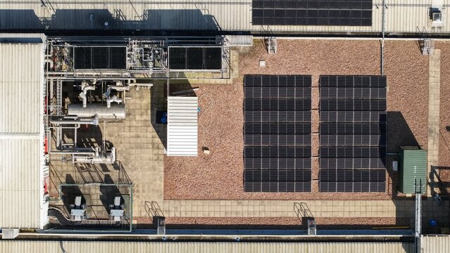 Aerial view of the rooftop's industrial complexity, where solar panels bask in the sun's embrace alongside cooling systems, Worksop, England, United Kingdom.