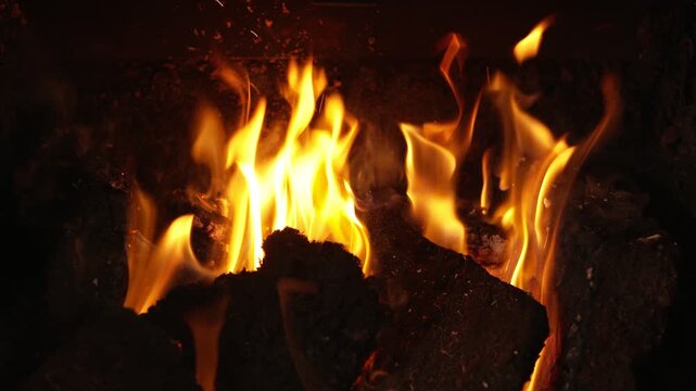 Close up shot of flames licking inside an open peat fire on the Isle of Lewis.