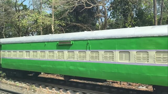 Slow Moving Train Window View with Old Abandoned Indian Railway Coach Outside