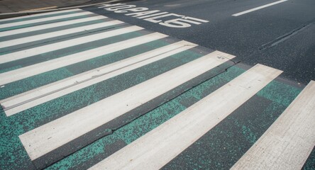 Fototapeta premium Marked outdoor pedestrian crossing with green colored lines