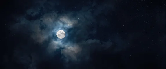 Full moonlight filtering through gauzy clouds under a vast dark starry sky © vxnaghiyev