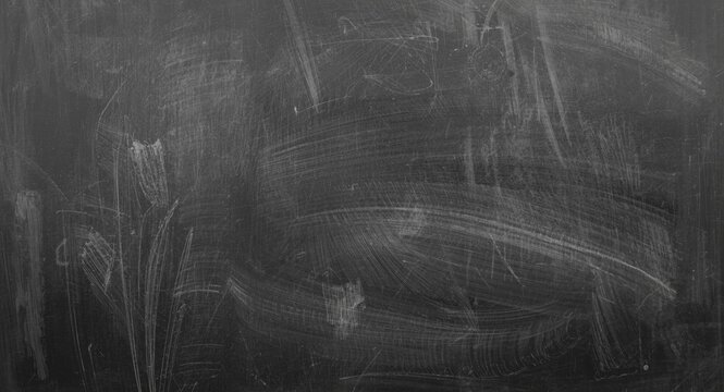 Grey chalk patterns on dark board in detailed monochrome photography