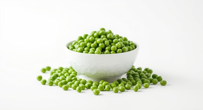 Close up of fresh green peas in a bowl with loose peas arranged around on white background