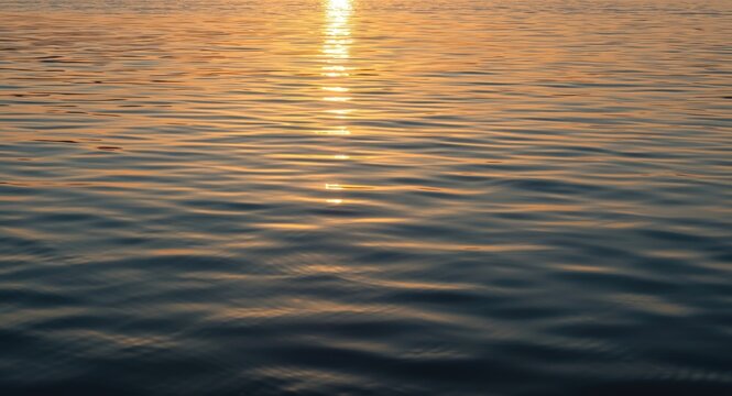 Reflective water scene at sunset with bright gold and soft blue