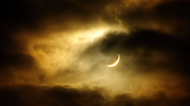 Dramatic Solar Eclipse Against Stormy Clouds