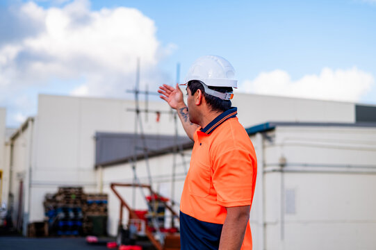 Samoan man in high vis clothing giving hand signals